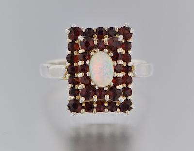 A Ladies' Opal and Garnet Ring