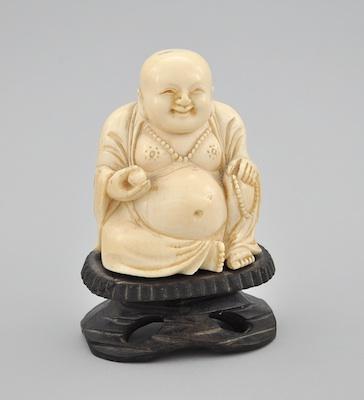 A Carved Ivory Figure of Seated Buddha