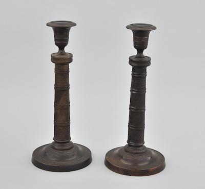 A Pair of Cast Metal Candlesticks b66f1