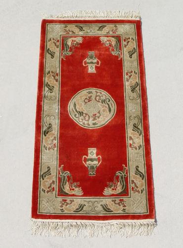 CHINESE RED SILK RUG: Central medallion