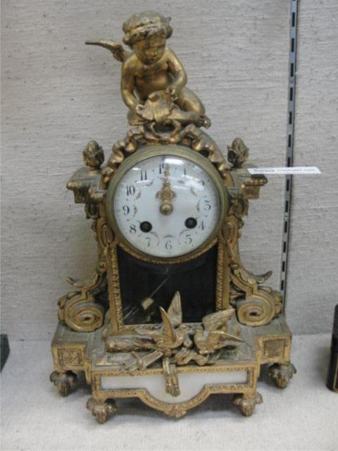Gilt Metal Clock with Porcelain Face.