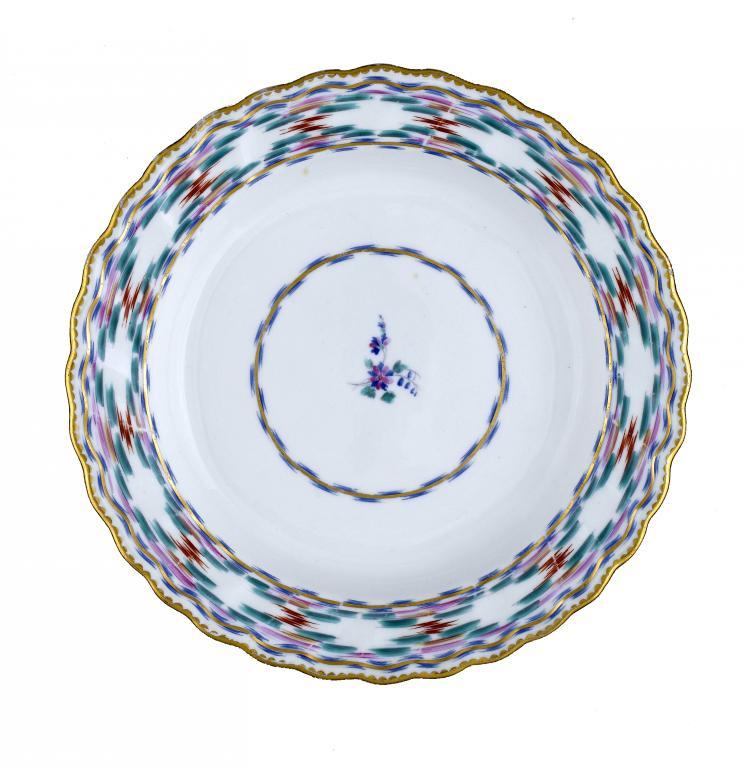 A DERBY PLATE
enamelled with the Chintz