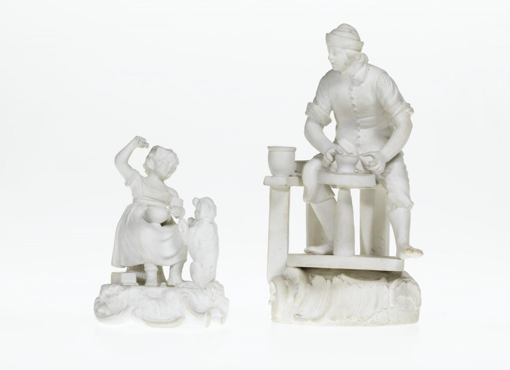 A DERBY BISCUIT FIGURE OF A POTTER seated 10941e