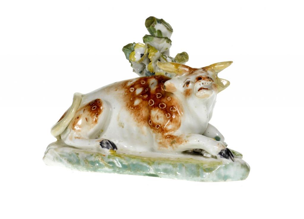 A DERBY MODEL OF A RECUMBENT BULL enamelled 109647