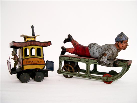 Two early 1900s tin toys: a boy