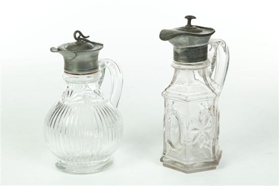 TWO GLASS SYRUP PITCHERS.  American