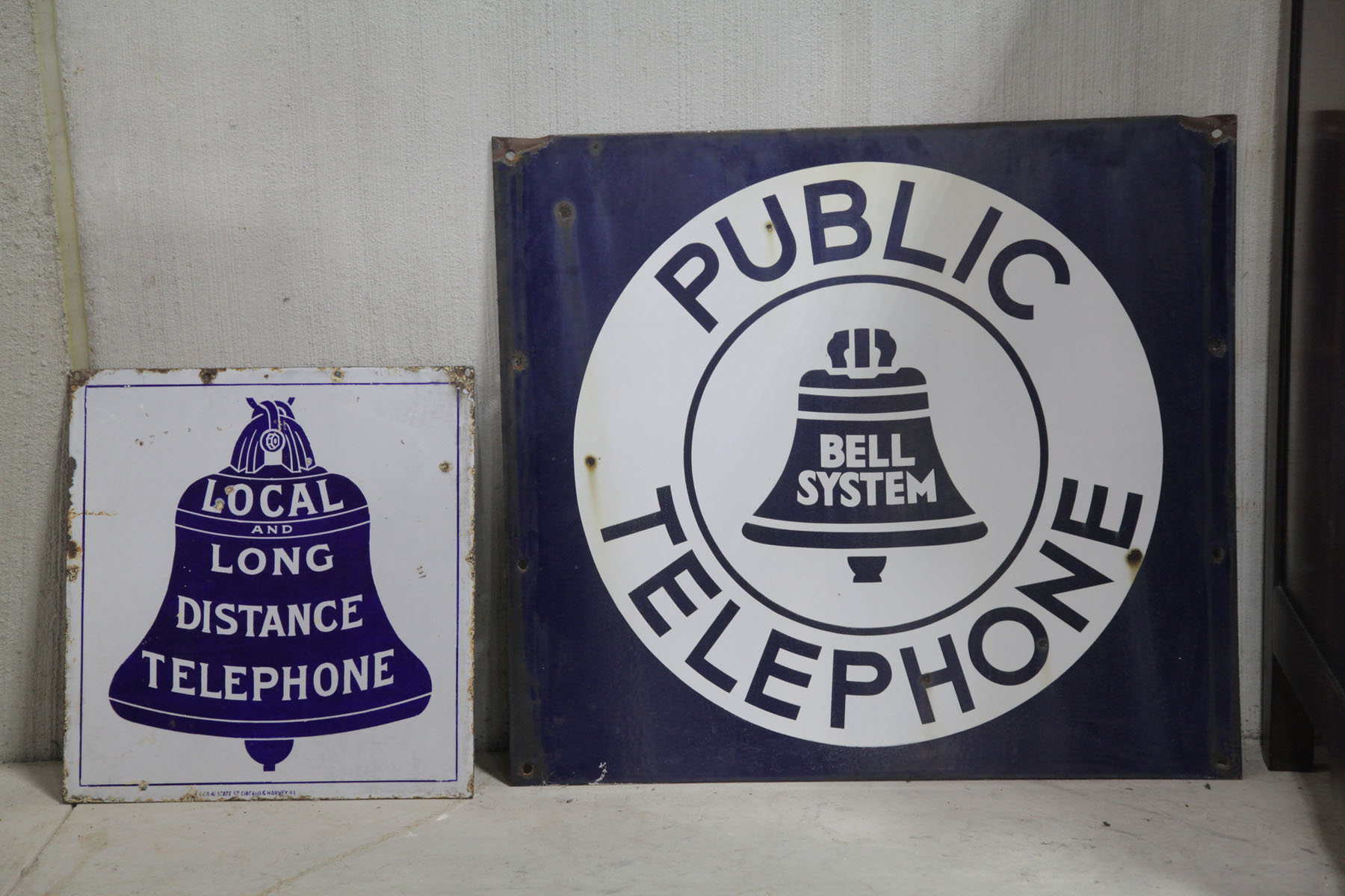 TWO TELEPHONE SIGNS.  American