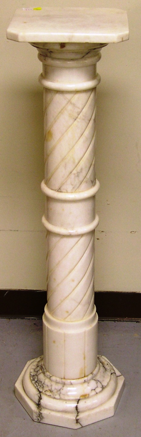 White marble pedestal with carved