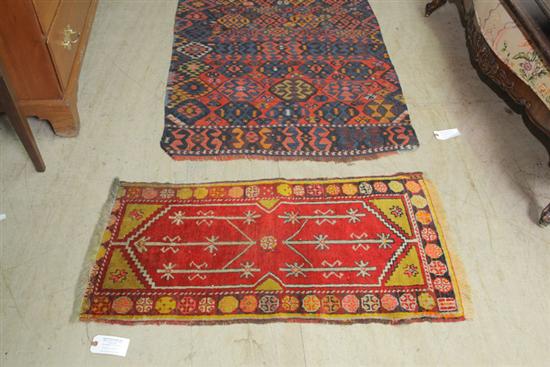 TWO RUGS. A polychrome runner with