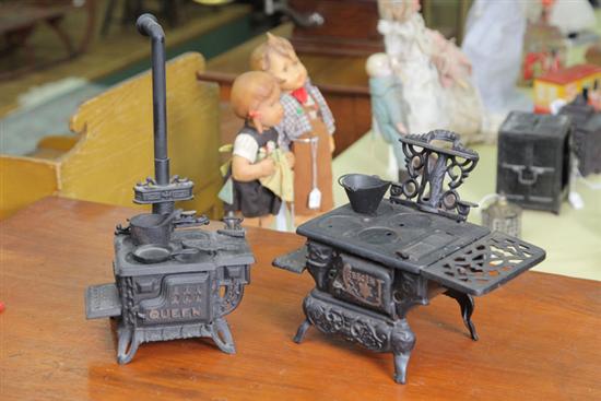 TWO TOY STOVES. Both are cast iron with