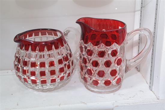 TWO RUBY AND CLEAR PITCHERS. One pitcher