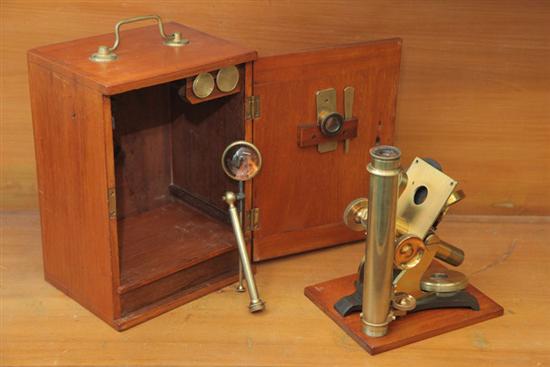 CASED MICROSCOPE. Brass and signed