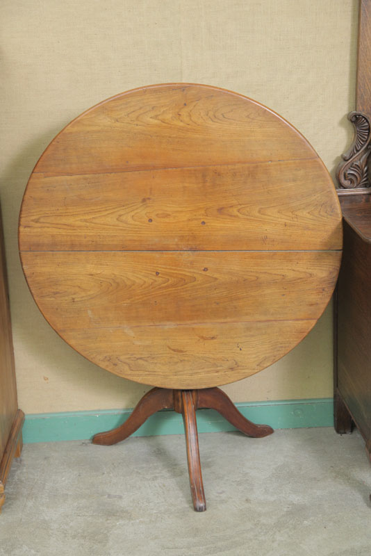 TILT TOP TABLE. Walnut having a