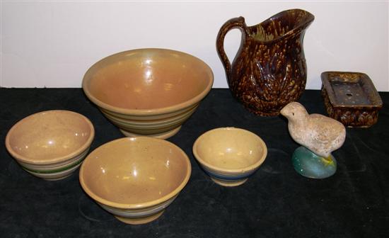 Four assorted size yellowware bowls