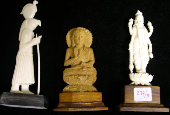 Three carved figurines on bases: