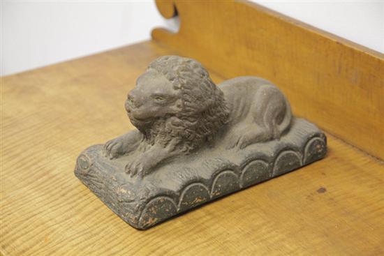 POTTERY LION. Recumbent lion on molded