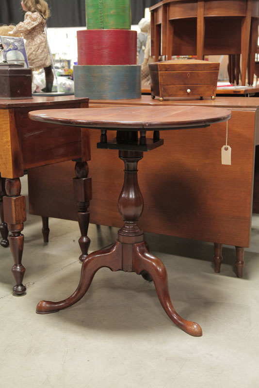 TILT TOP TABLE. Walnut having a