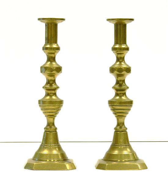 Pair of antique brass push-up candlesticks