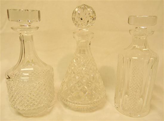 Three cut glass decanters of varying