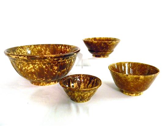 Four Rockingham type glazed bowls