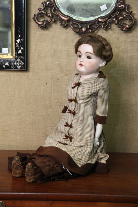 BISQUE HEAD DOLL. Brown sleep eyes and
