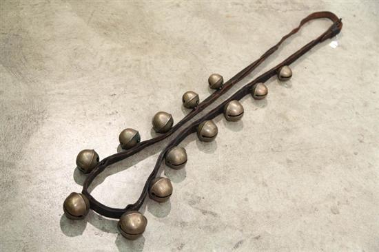 STRING OF BRASS SLEIGH BELLS. Thirteen