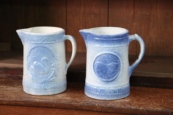 TWO BLUE AND WHITE STONEWARE PITCHERS.