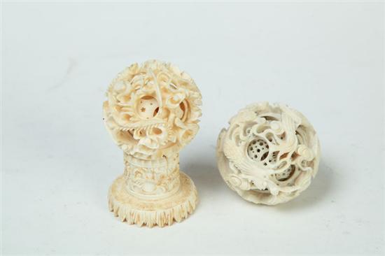 TWO CARVED IVORY PUZZLE BALLS.