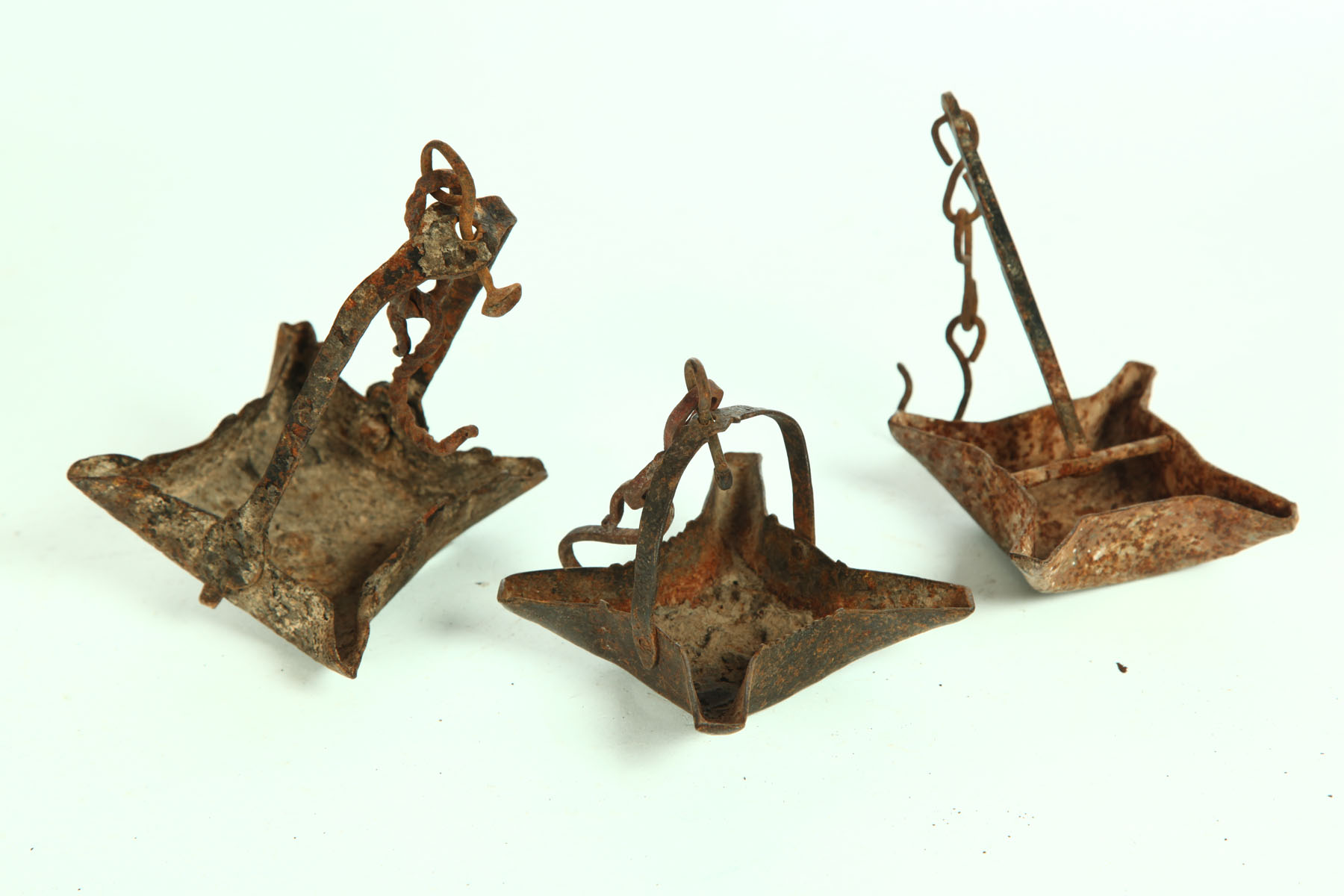 THREE WROUGHT IRON GREASE LAMPS.