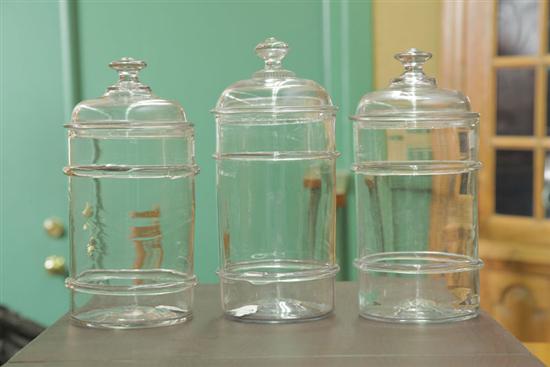 THREE BLOWN GLASS CANISTERS. Colorless