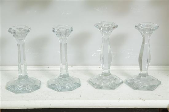 FOUR HEISEY GLASS CANDLESTICKS.