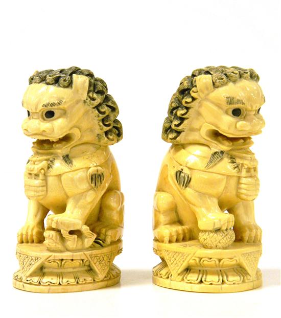 Pair of carved ivory foo dogs  121119