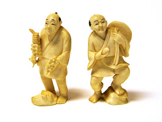 Pair of ivory figures including: man