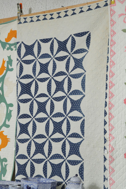 BLUE AND WHITE PIECED QUILT. Heavily