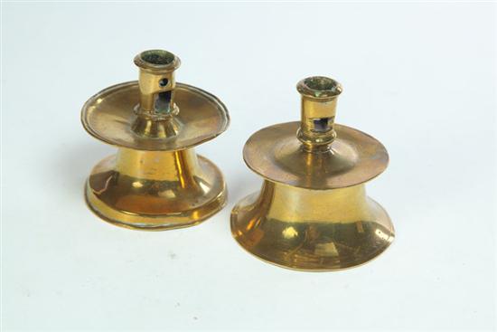 TWO BRASS CAPSTAN CANDLESTICKS.