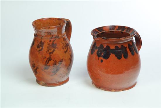 TWO REDWARE PITCHERS.  American  mid