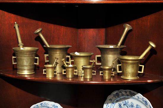 NINE BRASS MORTARS AND PESTLES. Graduated