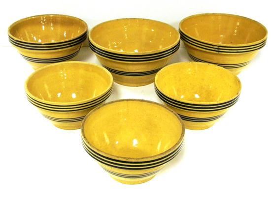 Six yellow ware blue striped bowls