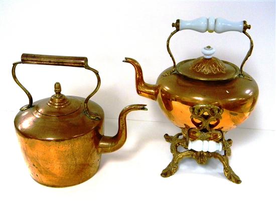 Two copper teapots one on burner 120cdc