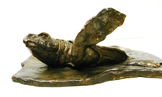 Bronze plaque of sea turtle breaking