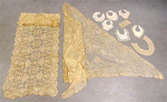 Two ecru lace shawls  some damage  along