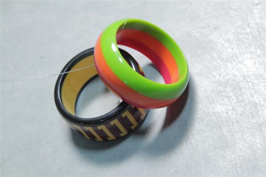 TWO BAKELITE BRACELETS. One laminated