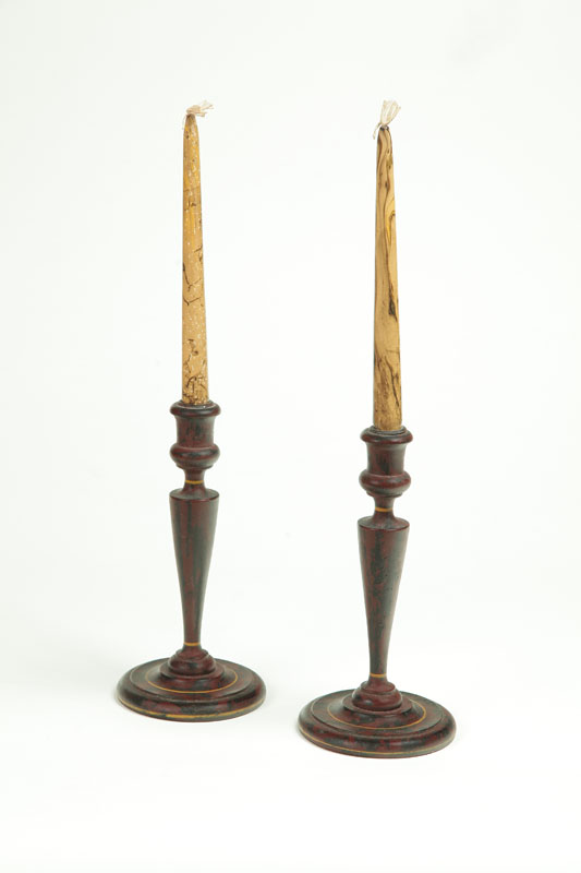 PAIR OF DECORATED TREEN CANDLESTICKS.