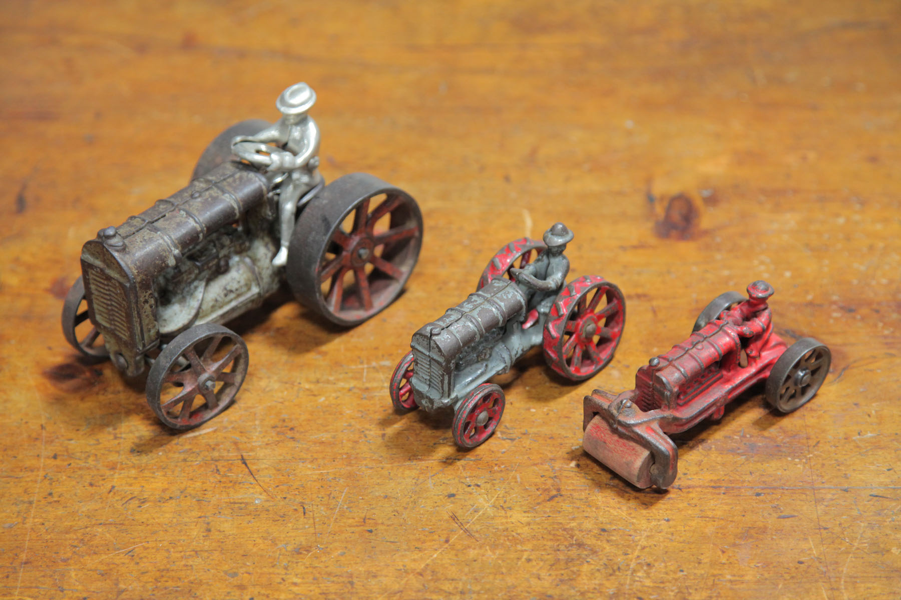 TWO CAST IRON TRACTORS AND A ROAD 122cdd