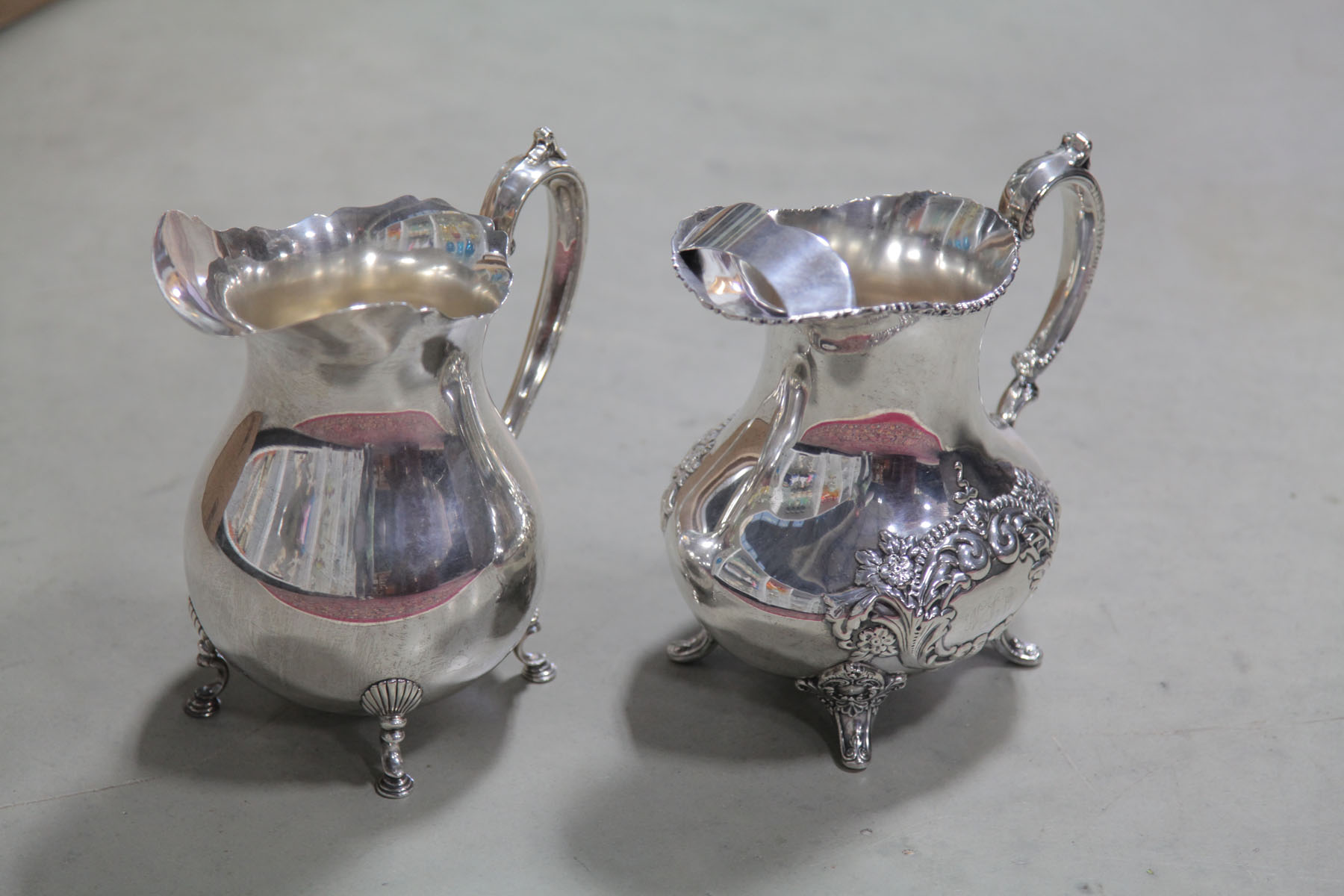 TWO STERLING SILVER WATER PITCHERS.