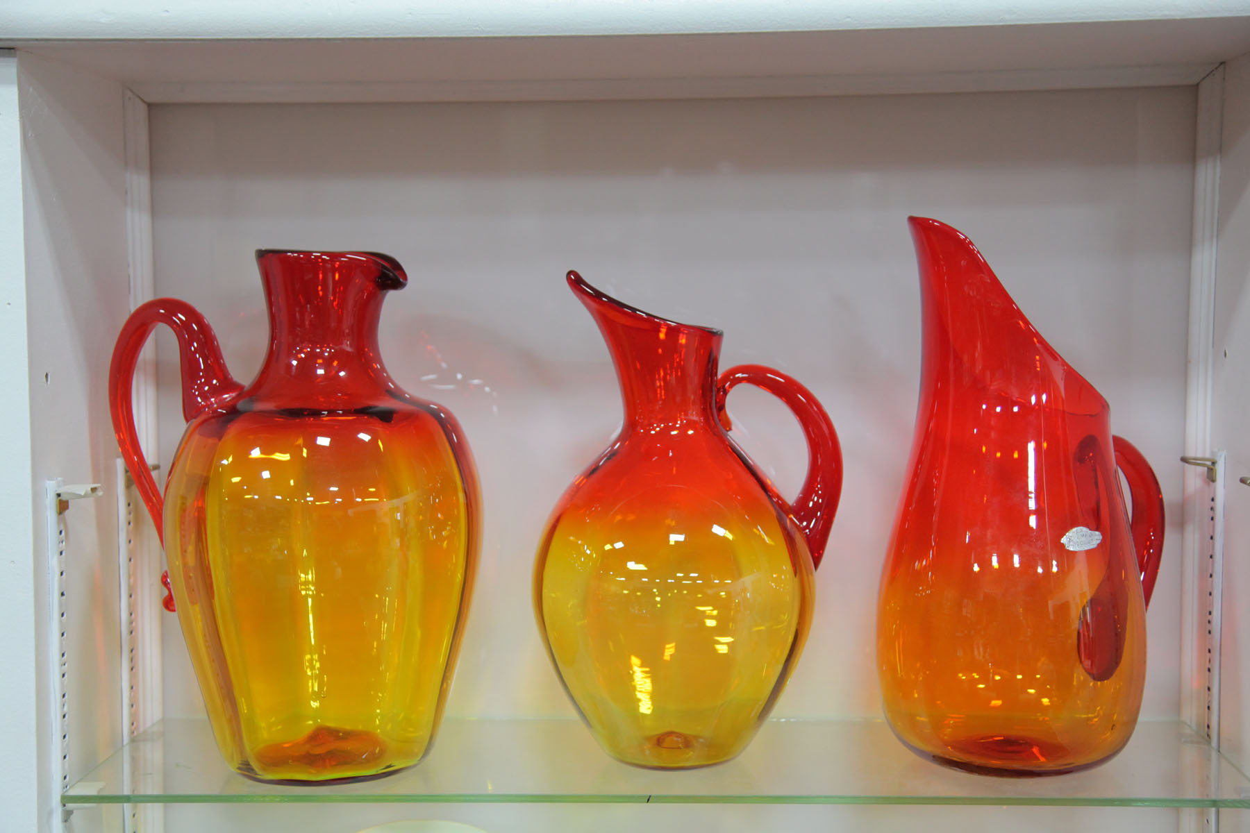 THREE BLENKO GLASS PITCHERS.  West