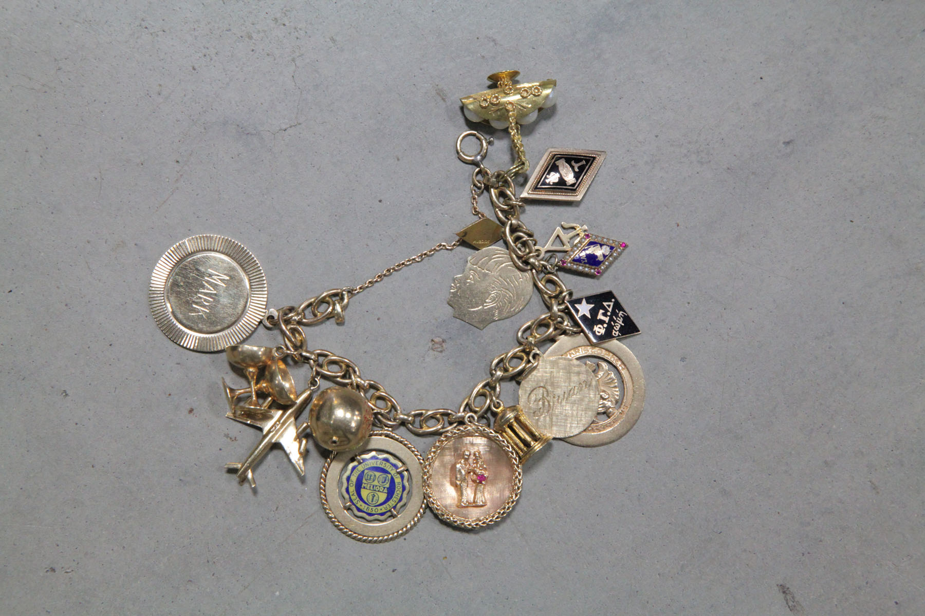 CHARM BRACELET AND CHARMS.  Gold