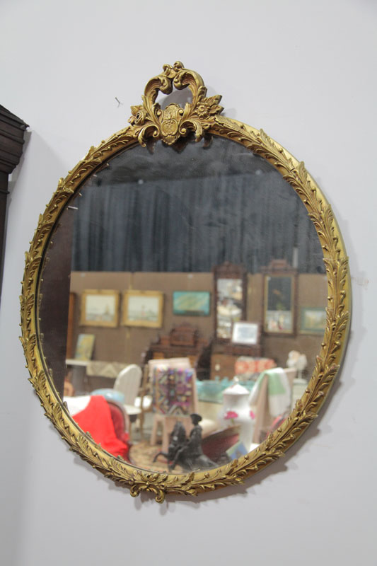 FRAMED MIRROR. Round and gilt mirror