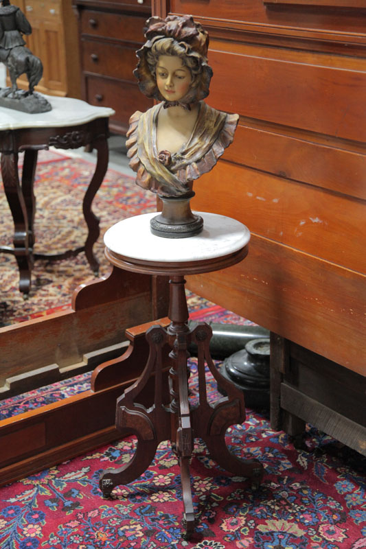 BUST ON STAND. Plaster sculpture depicting