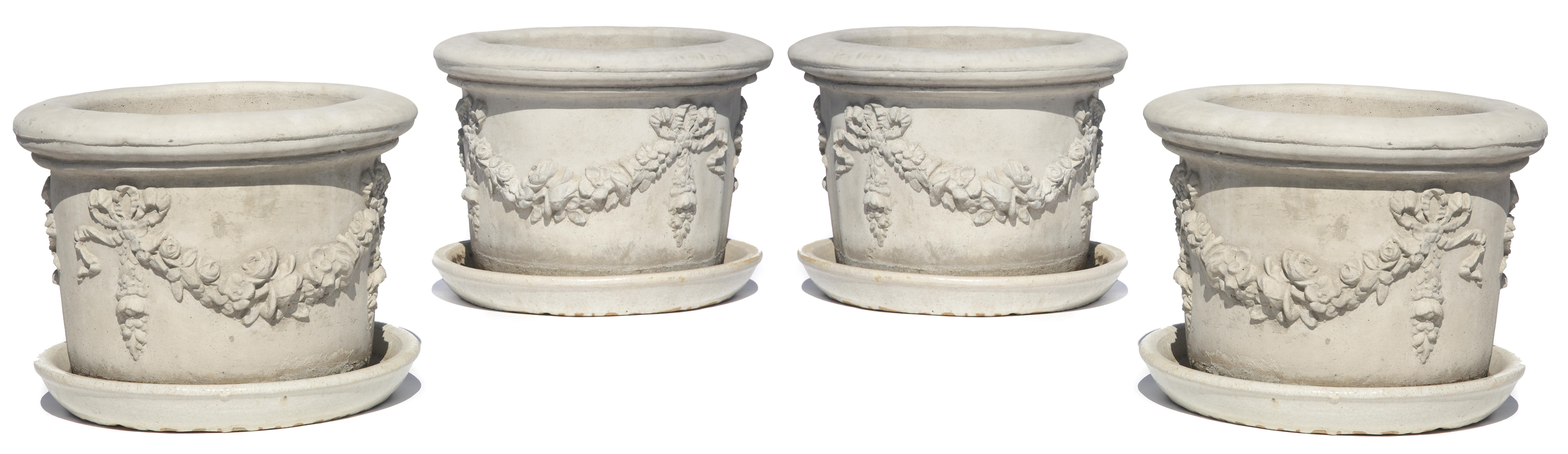 A set of four cast stone jardinires